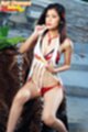 Seated on leopard print rug pulling at top baring bra red shiny panties