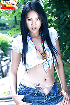 Nancy Ho standing with hands on hips long hair wearing blue knotted shirt and denim shorts