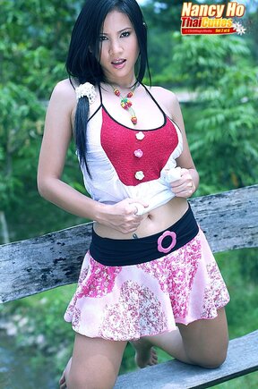 Busty Nancy Ho strips on bench and plays with bottle