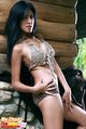 Leaning against cabin wall wearing bikini