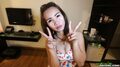 Flashing vee signs wearing flowered top pushing her breasts together